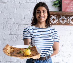 A staff member holding a galette