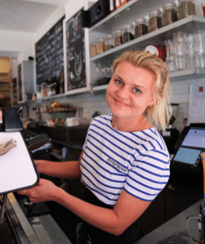 Staff member working behind the till